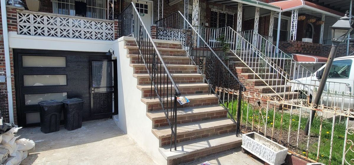 Stoop, railings, facade and garage door